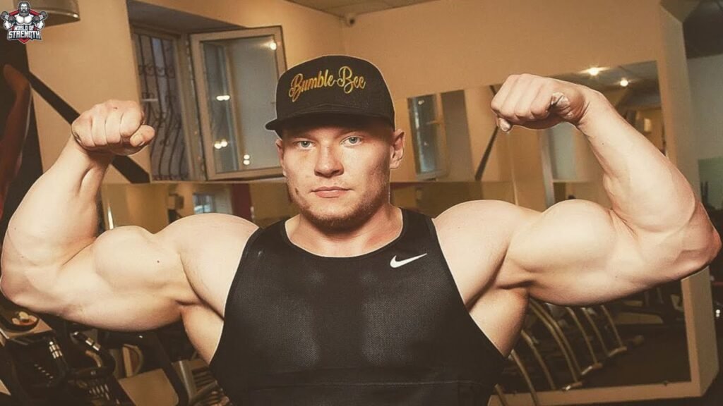 Artyom Morozov flexing his arm, showcasing his incredible strength and form as a rising star in professional arm wrestling.